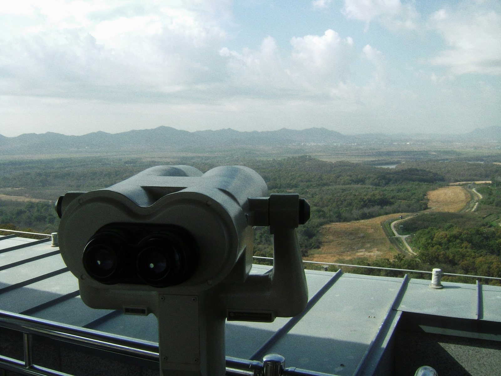 Viewing binoculars at a DMZ observatory overlooking the Korean border landscape
