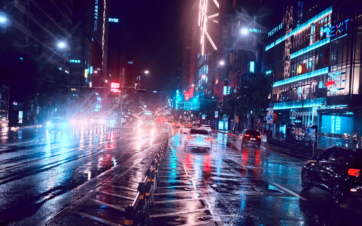 Rain reflecting neon lights along Yanghwa-ro in Seoul.