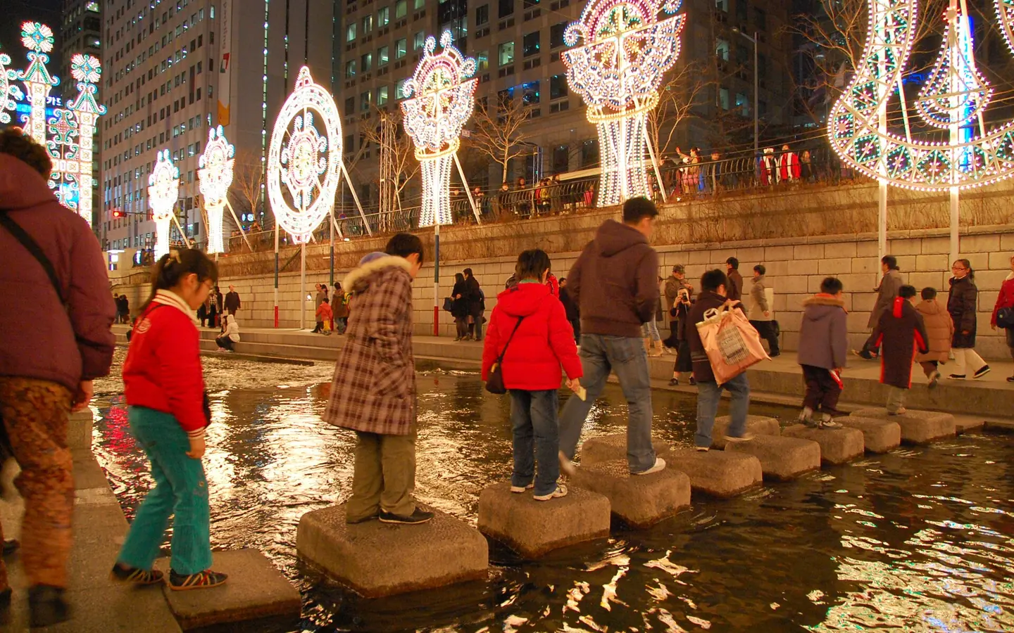 Cheonggyecheon Stream illuminated during winter.